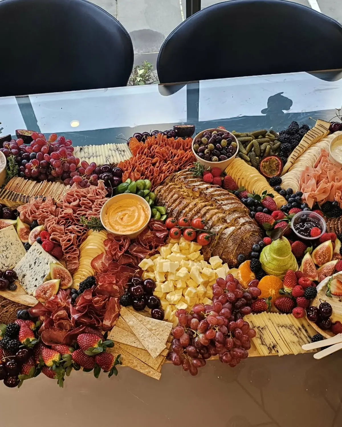 A colourful grazing spread with cheeses and seasonal produce